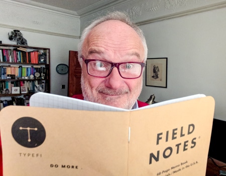 Peter Kahrel holding up a Typefi Field Notes booklet
