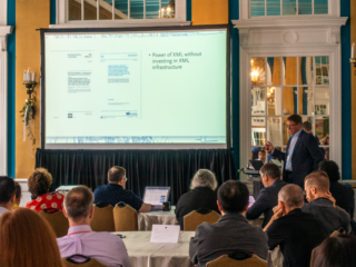 Jason Mitchell presenting at the 2019 Typefi User Conference. The screen reads: "Power of XML without investing in XML infrastructure."