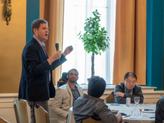 Per Thrane-Nielsen presenting his group's ideas while the rest of his group looks on.