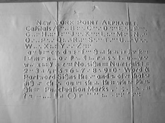 A page printed with embossed New York Point lettering.