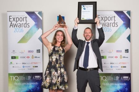 Typefi Marketing Associate Shanna Bignell and Financial Controller Michael Cousins raise their 2016 Premier of Queensland’s Small Business Export Award overhead in celebration.