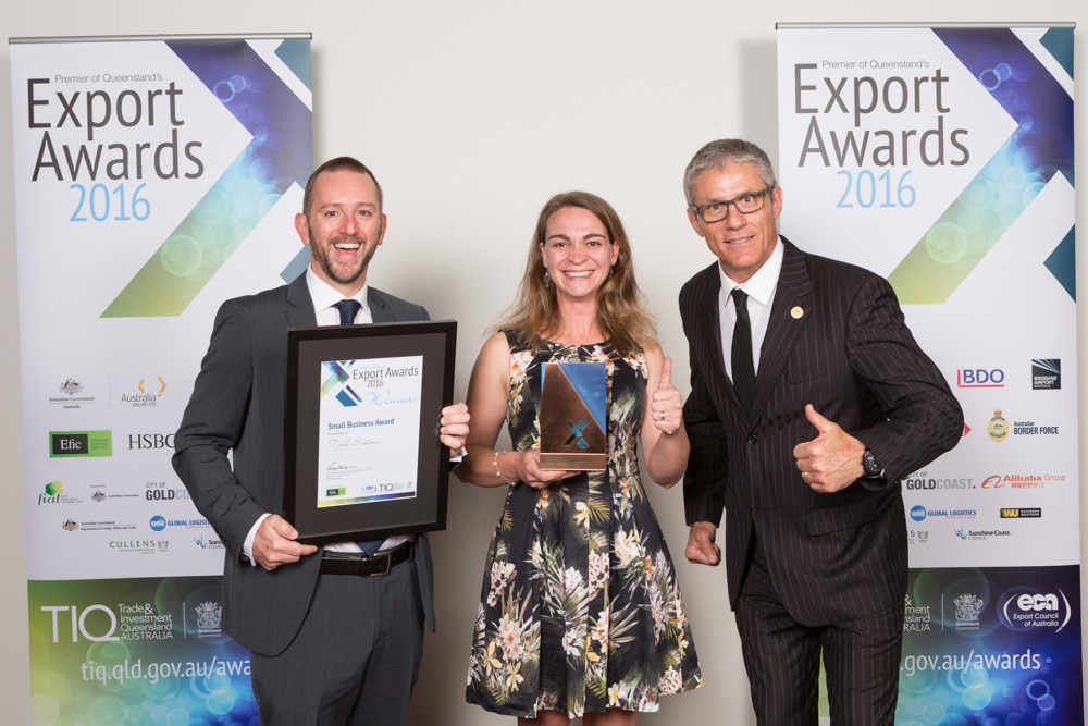 Typefi Marketing Associate Shanna Bignell and Financial Controller Michael Cousins give a thumbs up with Sunshine Coast Council Deputy Mayor Tim Dwyer after Typefi won the 2016 Premier of Queensland’s Small Business Export Award.