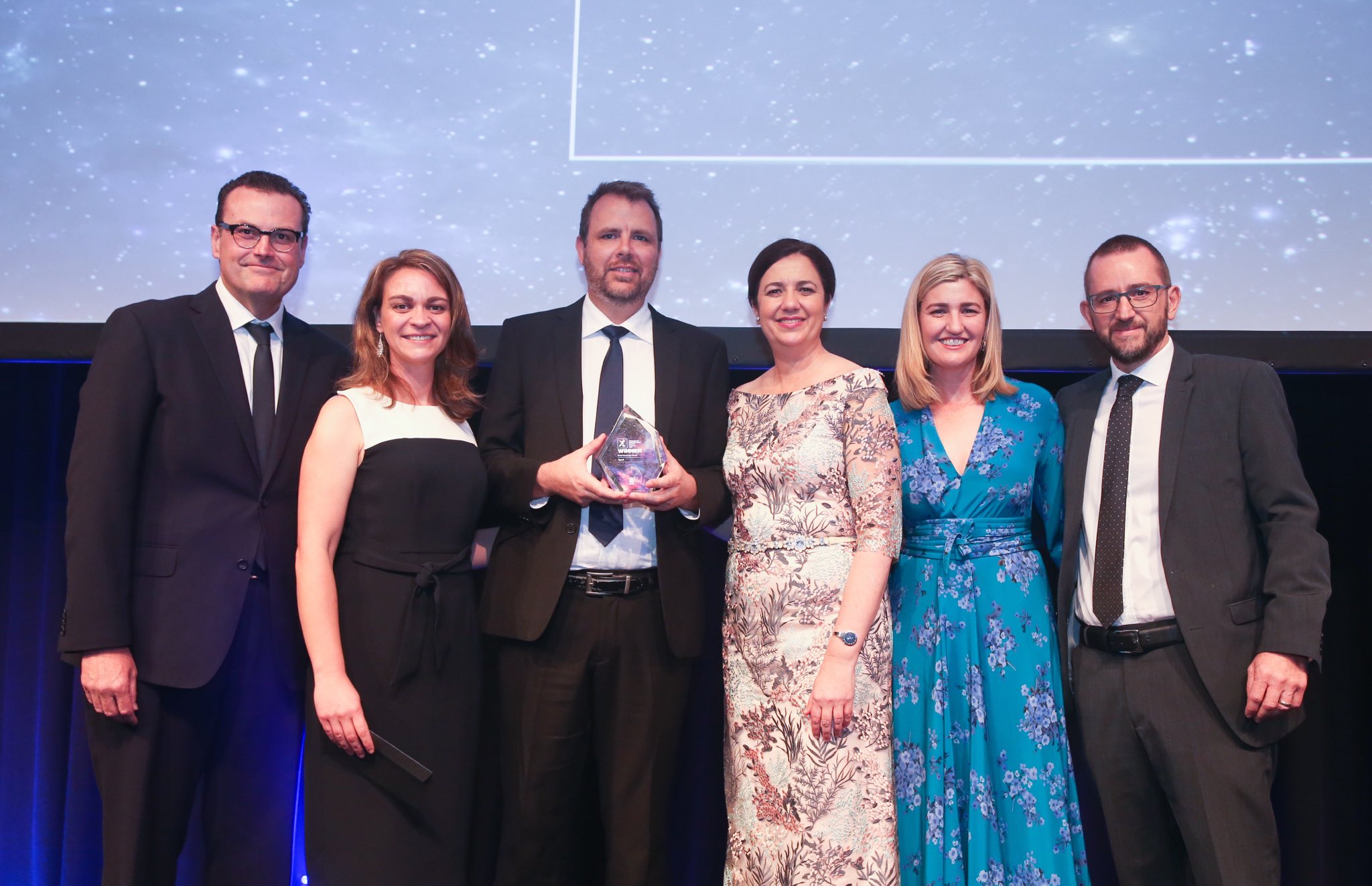 The Typefi team on stage at the 2018 Premier of Queensland's Export Awards with the award sponsor (Peter Neuendorf from CBA) and presenters (Premier of Queensland Annastacia Palaszczuk, and Queensland Minister for Employment and Small Business Shannon Fentiman).