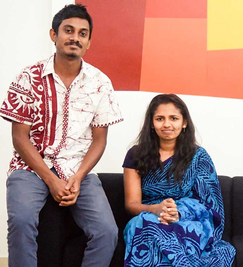 Ramesh and Apsara sit smiling on a couch in Typefi's Colombo office