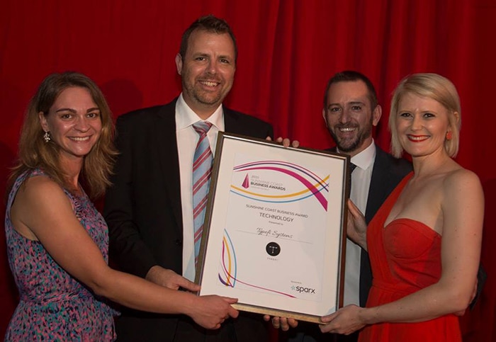 Australian Typefi team members Shanna Bignell, Ben Hauser and Michael Cousins with a with a representative from Technology Award sponsor Sparx Digital.