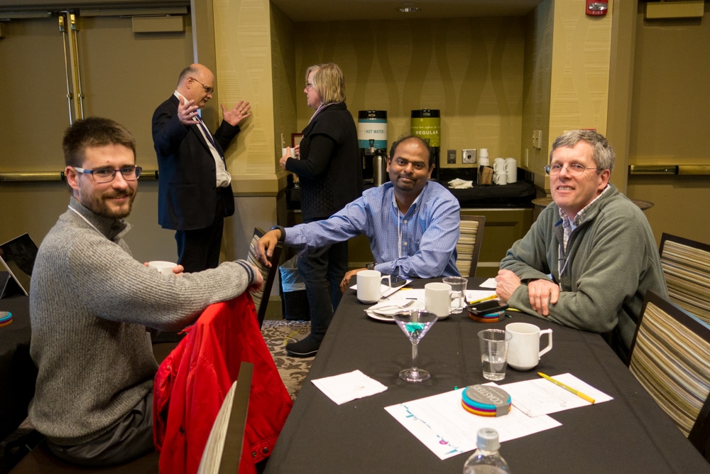 Ilya Kashtelyan from Impact Journals discusses solutions with Antony Gnanapiragasam and Allan Heathman from Sheridan Journal Services at the 2017 Typefi User Conference, while Typefi's Toby Waller has an animated discussion in the background with Coletta Perry from Avatar DPS.